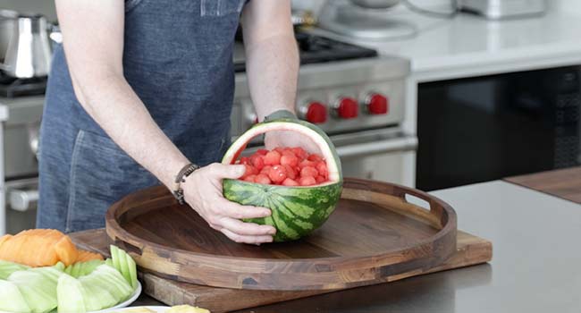 placing a watermelon basket on a tray