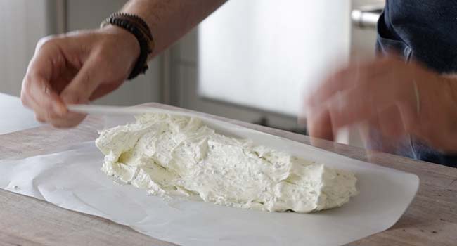 adding butter to parchment paper