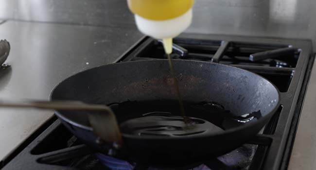 adding oil to a pan