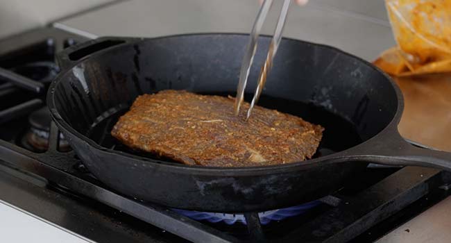 searing a steak in a pan