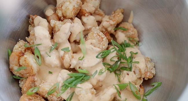 coating fried shrimp in bang bang sauce