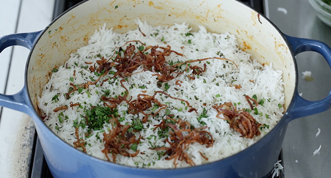 rice and fried onions in a pot