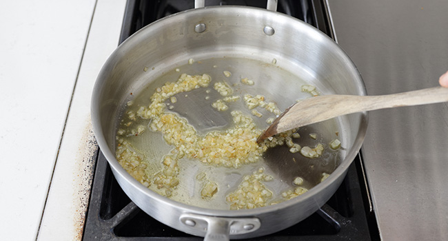 cooking garlic and shallots in a pan