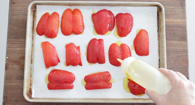 adding oil to peppers
