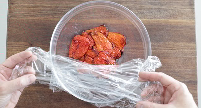 covering peppers with plastic wrap