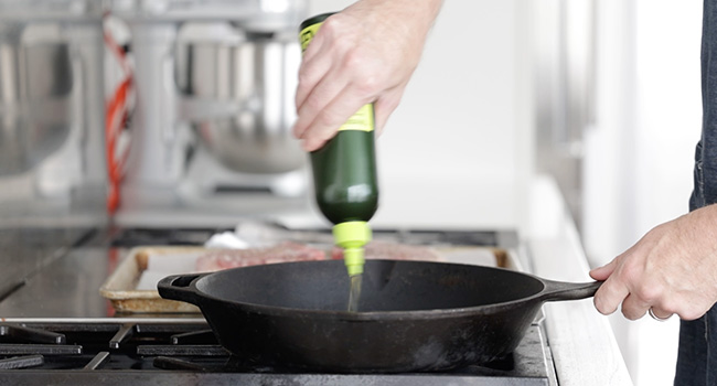 adding oil to a pan