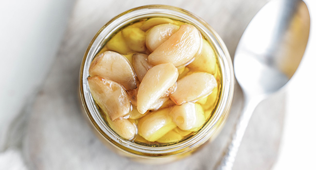 garlic confit in a jar with oil