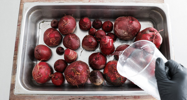 adding beets to a pan with water