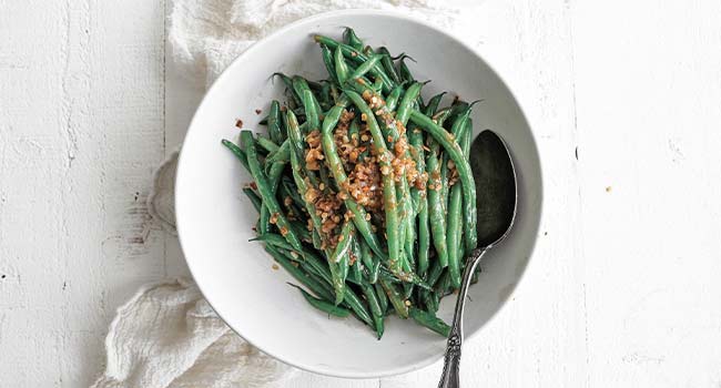 green beans in a bowl with shallots
