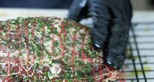 rubbing the outside lamb with an herb crust