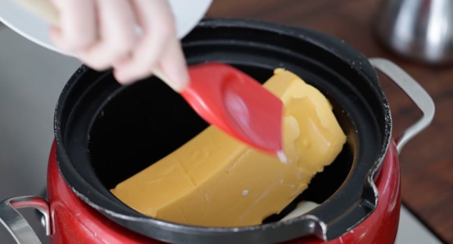 adding cheese to a slow cooker