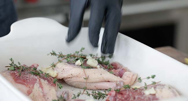 adding herbs to duck