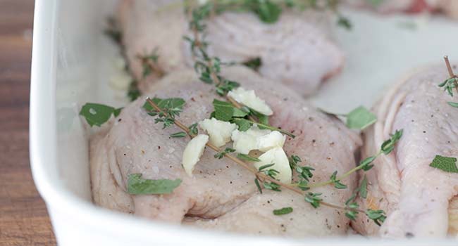 garlic and herbs on duck legs