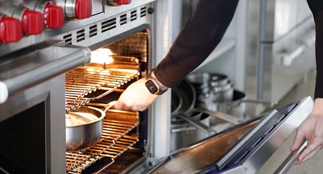 adding a pot to an oven