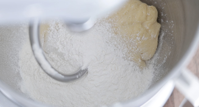 mixing flour with dough