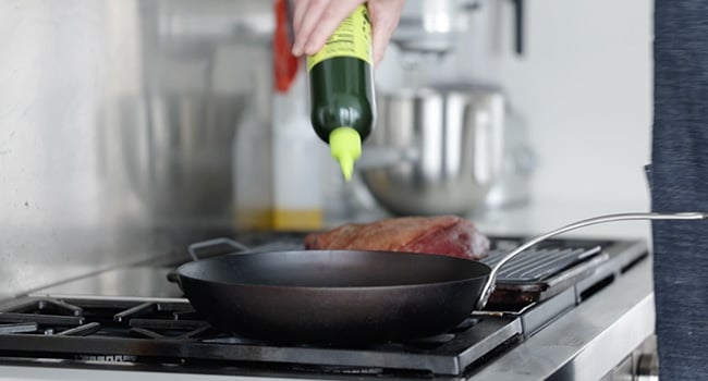 adding oil to a pan