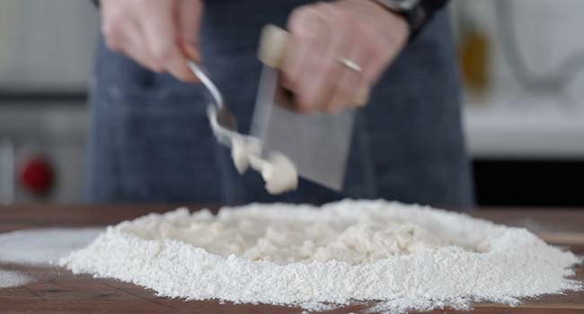 using a bench knife making dough