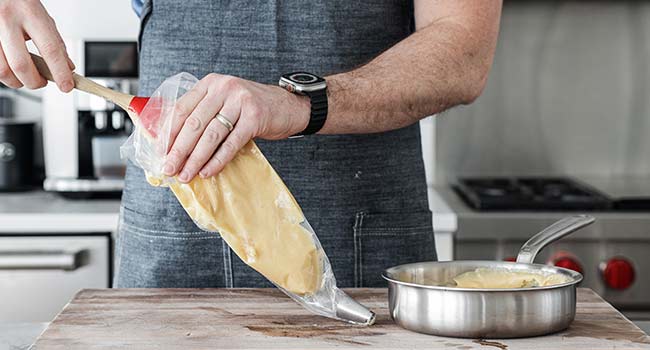 adding choux pastry to a piping bag