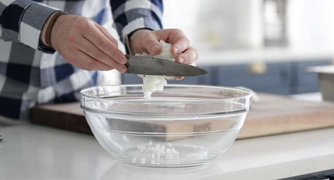 adding onions to a bowl