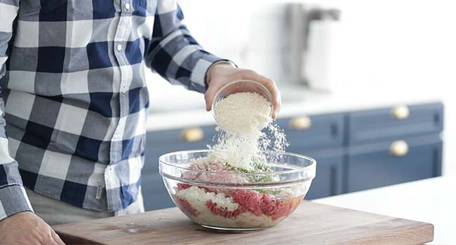 adding cheese to meatball batter