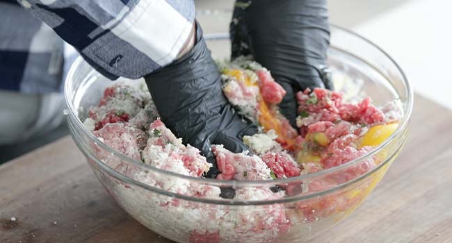 mixing together meatball recipe ingredients