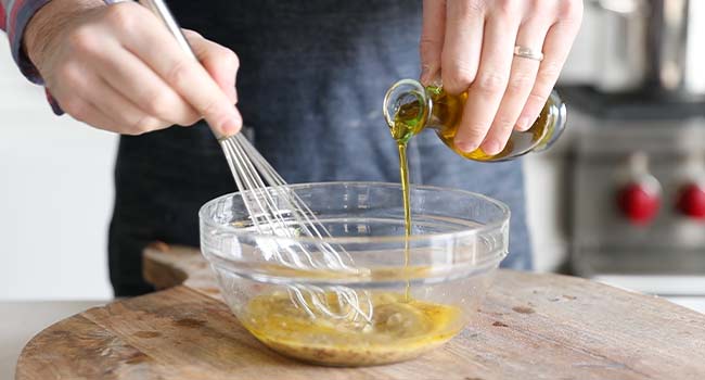 mixing vinaigrette ingredients in a medium size bowl