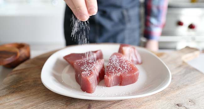 Season the tuna on all sides with salt and pepper
