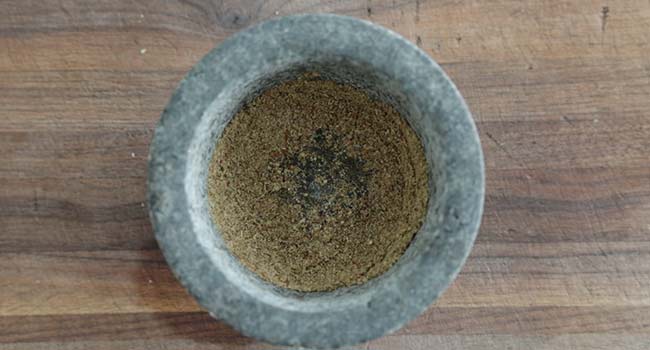grinding seeds in a mortar