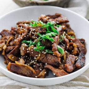 plated up beef bulgogi with sesame seeds and green onions