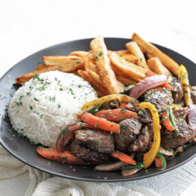 beef lomo saltado with french fries and rice