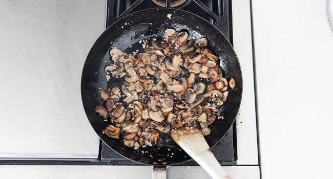 mixing together mushrooms and shallots