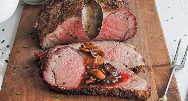 adding mushroom bordelaise to a strip roast