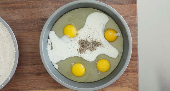 eggs, milk, and seasonings in a cake tin