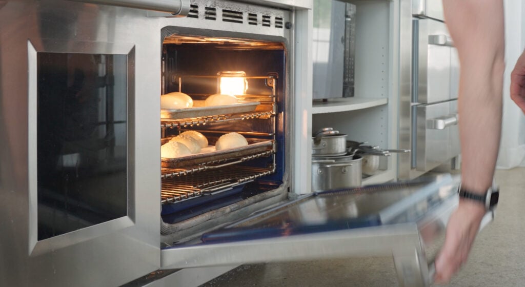 adding burger buns to the oven