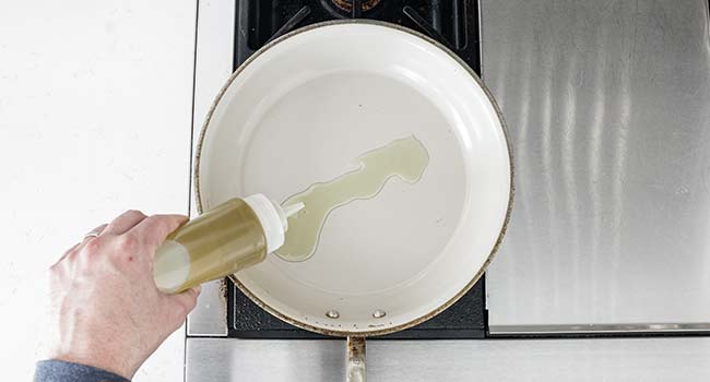 adding oil to a pan