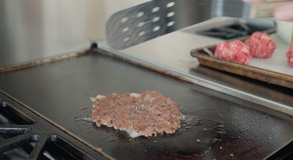 flipping over a burger patty