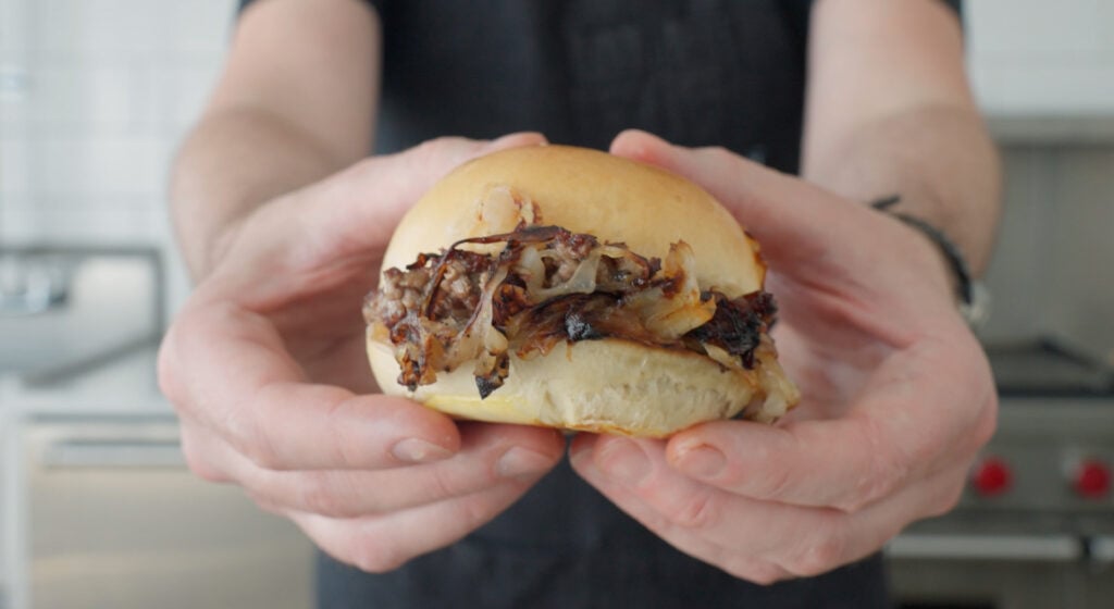 holding an oklahoma onion burger
