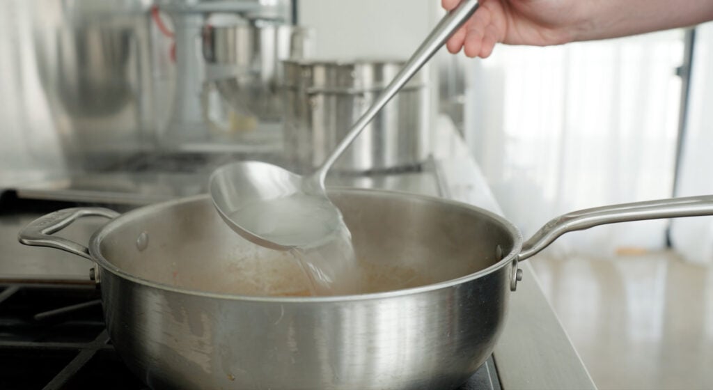 Adding pasta water to pan