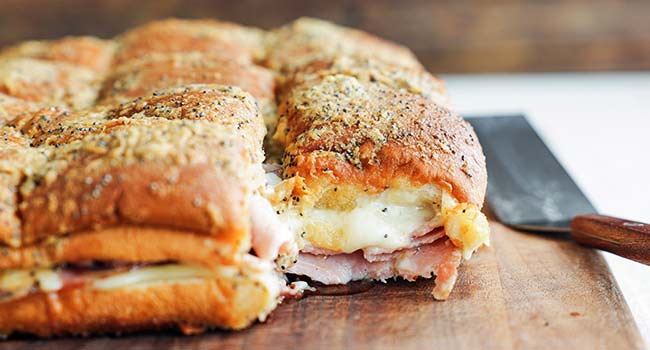 ham and cheese sliders on a cutting board