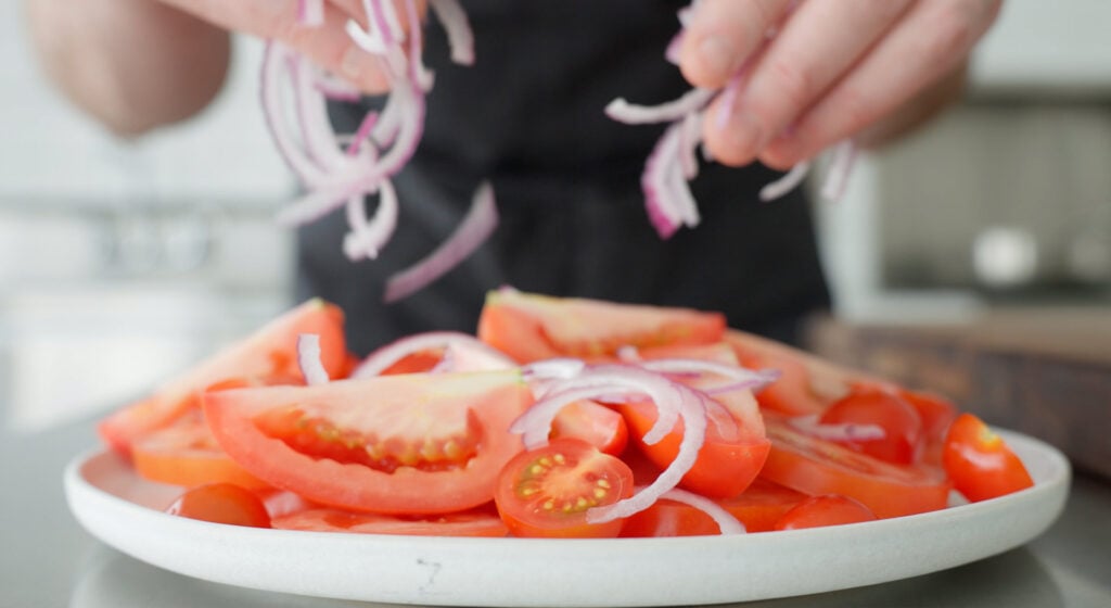onions sprinkled on top of tomatoes