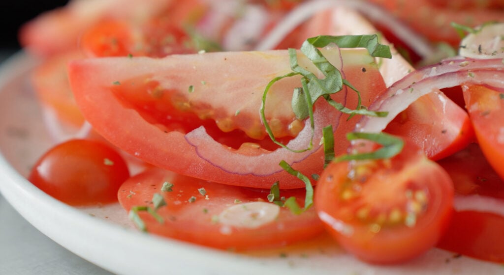 tomatoes topped with fresh basil