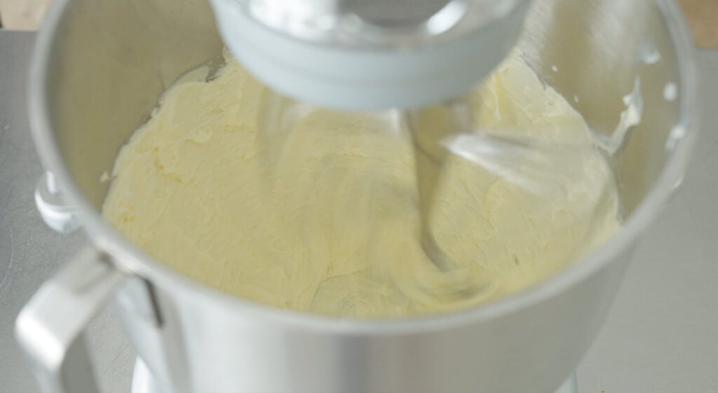 Beaten butter in the bowl of a stand mixer