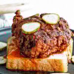 nashville hot chicken on a plate with pickles