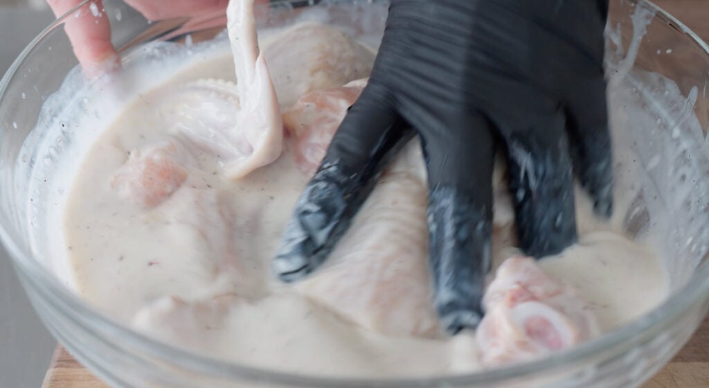 marinating chicken in a bowl