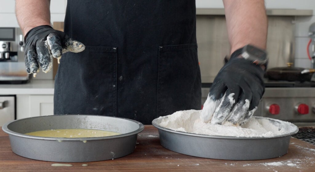 dredging chicken in flour mixture