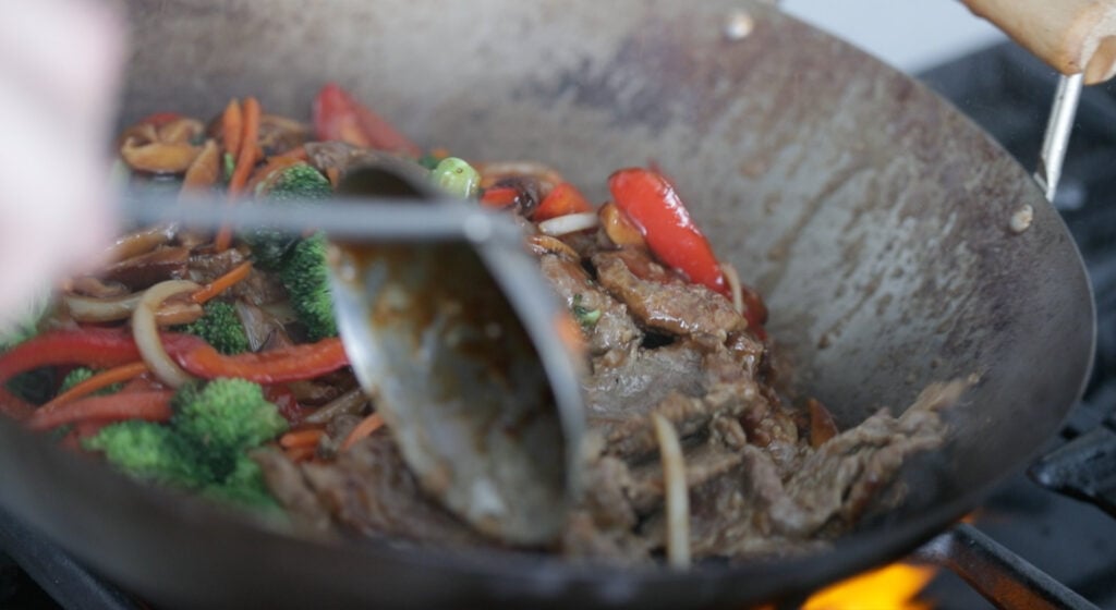 wok with the meat and vegetables.