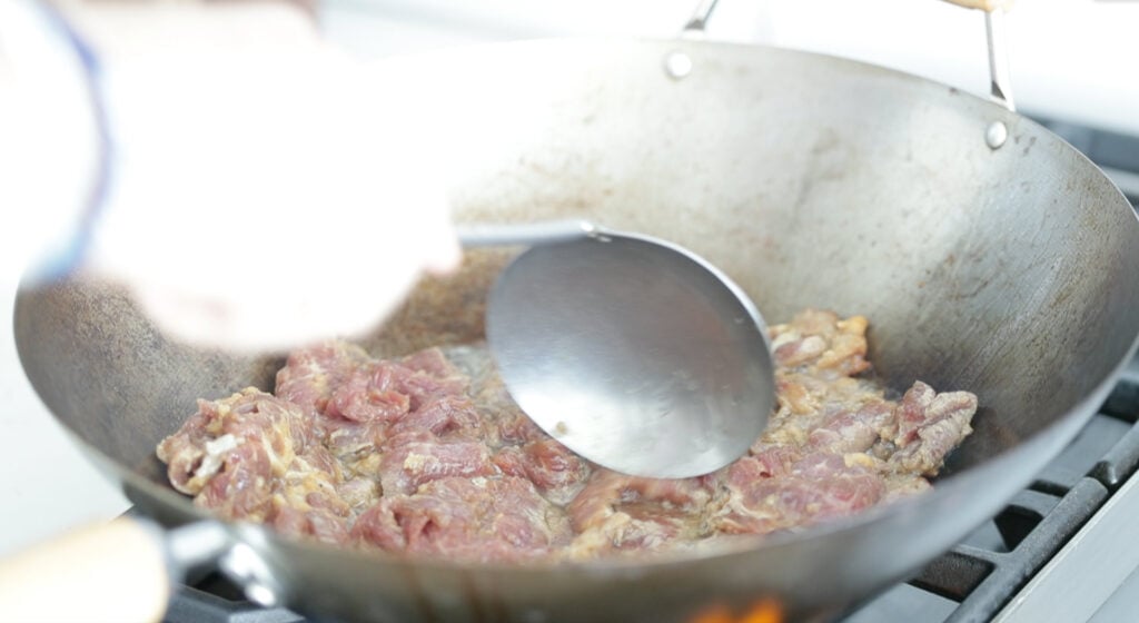 Add in the beef and push it outside of the pan 