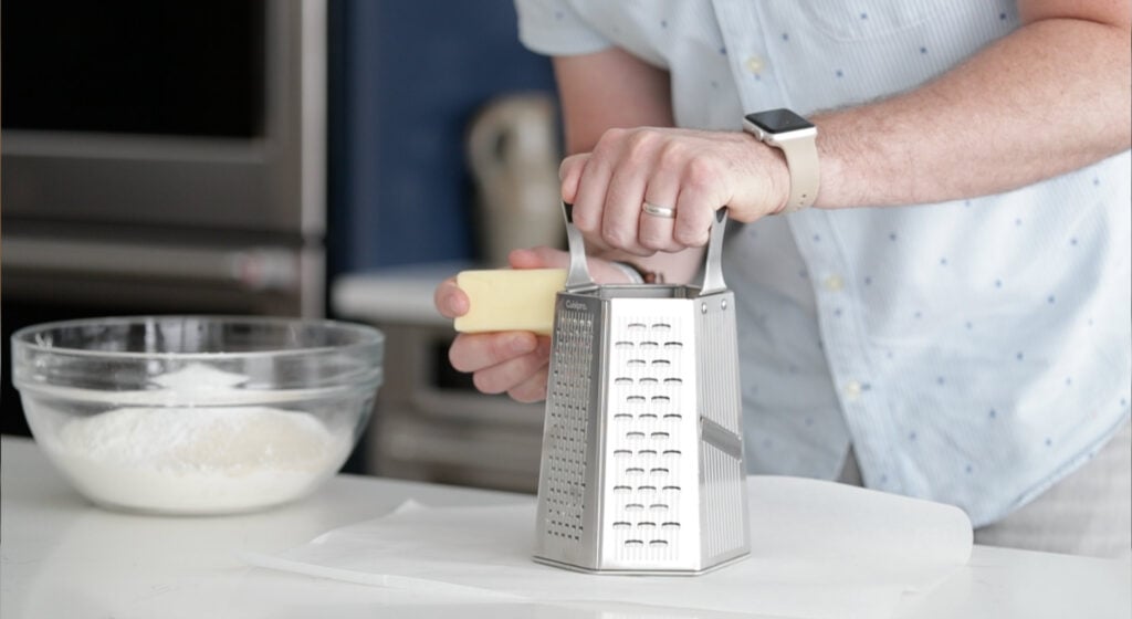 grate cold butter on a cheese grater.