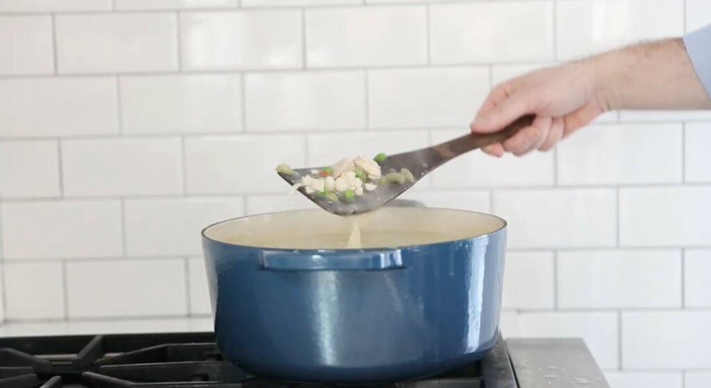 a pot of soup with hominy and peas