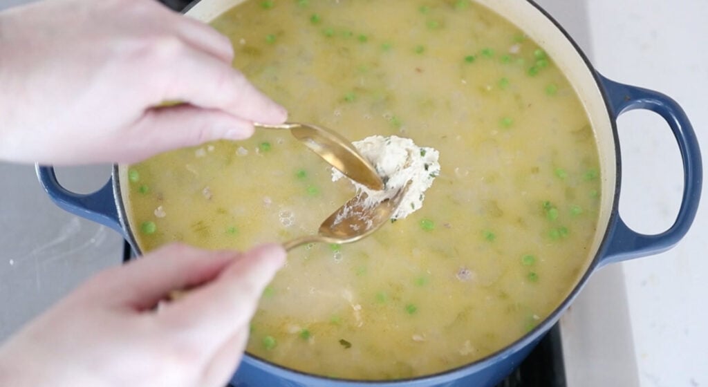 adding dumplings dough to the pot